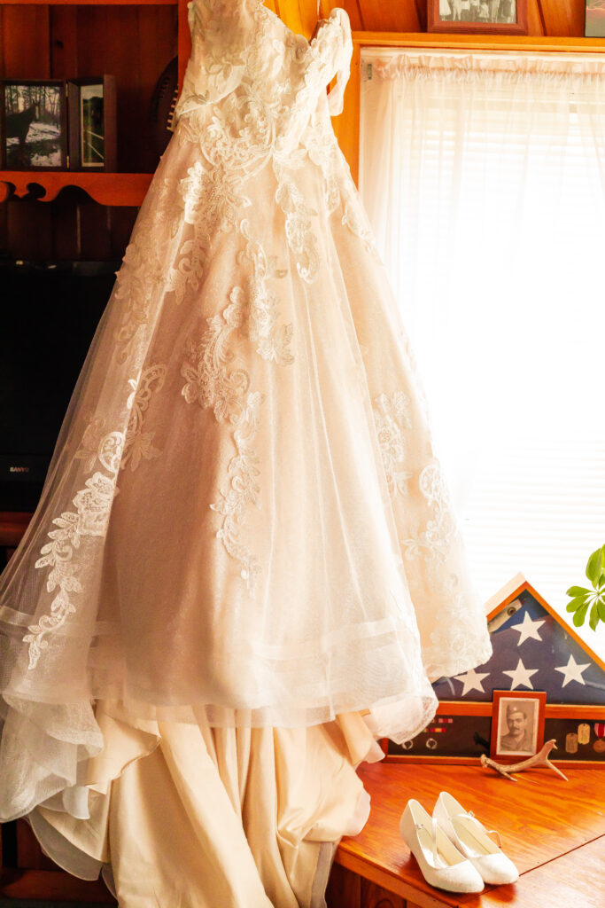 Jill's ballgown dress handing in their living room window on their wedding day.