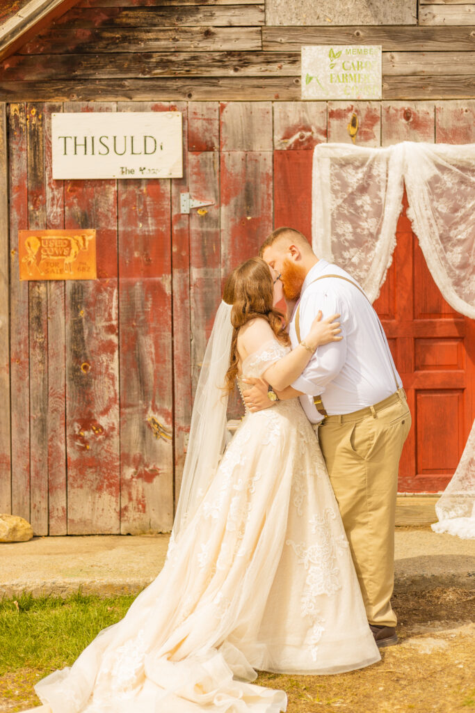 The bride and groom share their first kiss as husband and wife at their small elopement with their friends and family in Vermont.