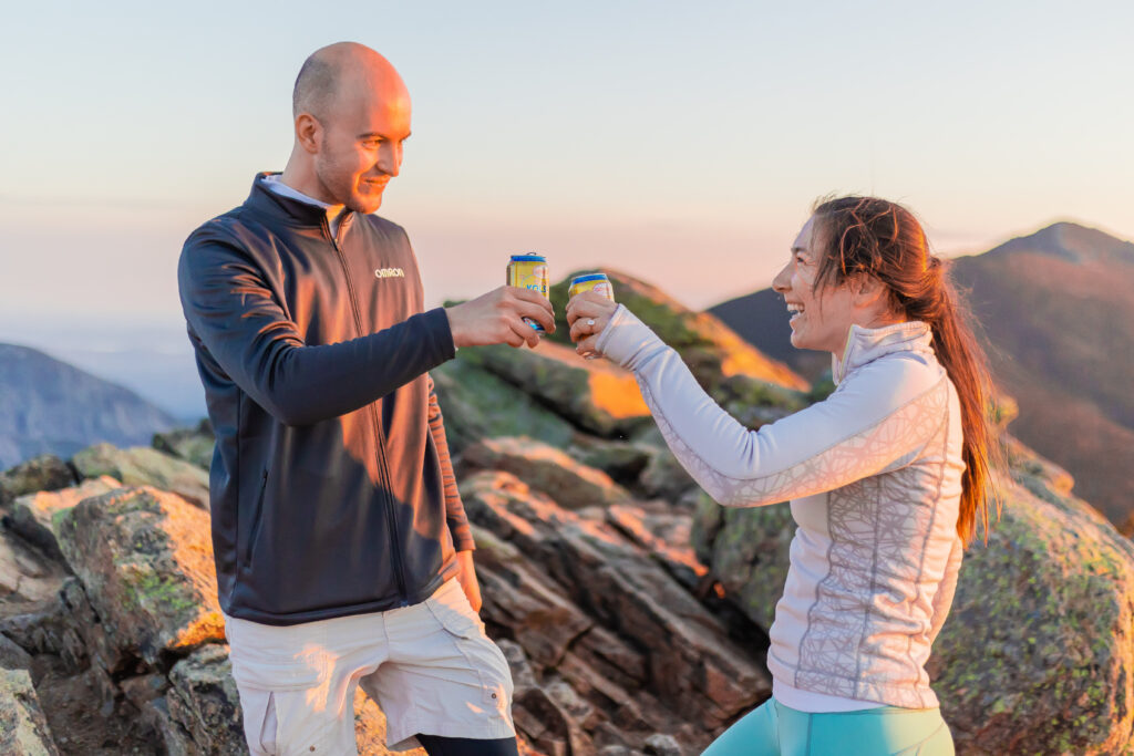 Doug and Amy raise a glass to getting engaged with Mount Lafayette in the distance. 