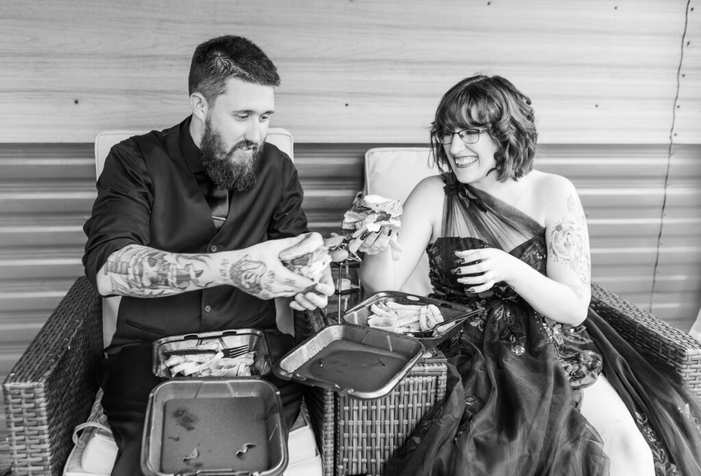 The bride and groom enjoy their cheeseburgers together after their first look at their new hampshire wedding. 