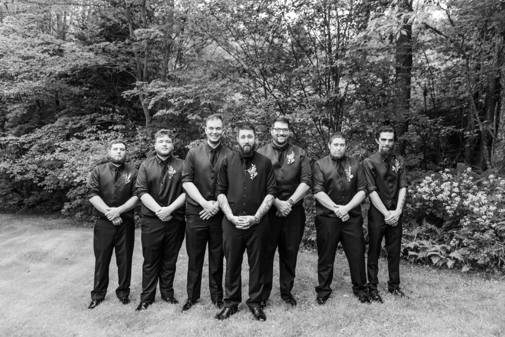 The groomsmen stand in V formation during the bride and groom's wedding in Groveton NH. 