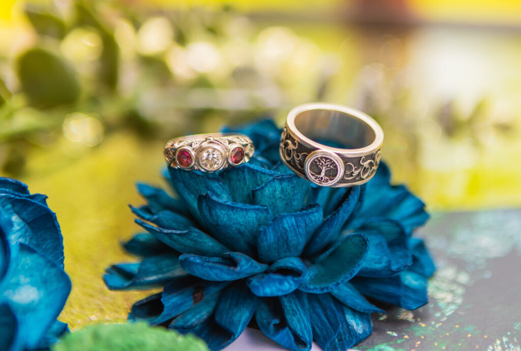 The bride and groom's rings on top of flowers from their NH wedding florist. 