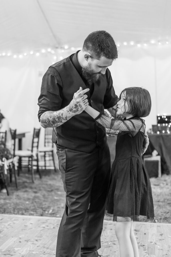 The groom and his daughter dance together at his wedding in New England. 