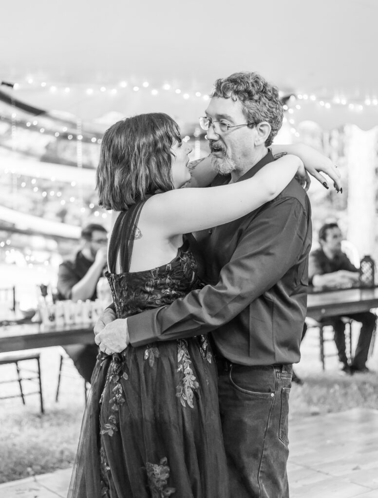Father and daughter share a first dance together. 