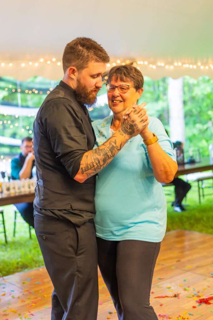 The groom and his mother share a dance at their outdoor wedding venue in New Hampshire. 
