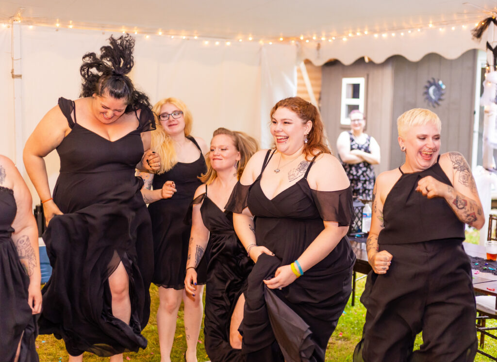 The bridal party dances to one of their favorite songs getting candid images at their wedding in NH. 