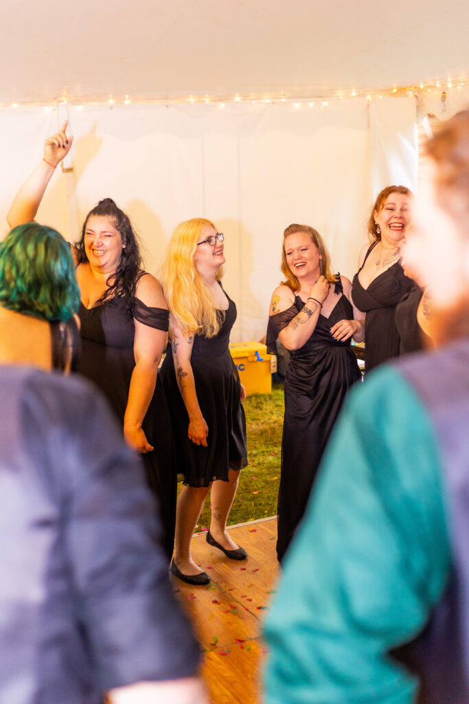 The bridesmaids sing and laugh together during the wedding reception in NH. 