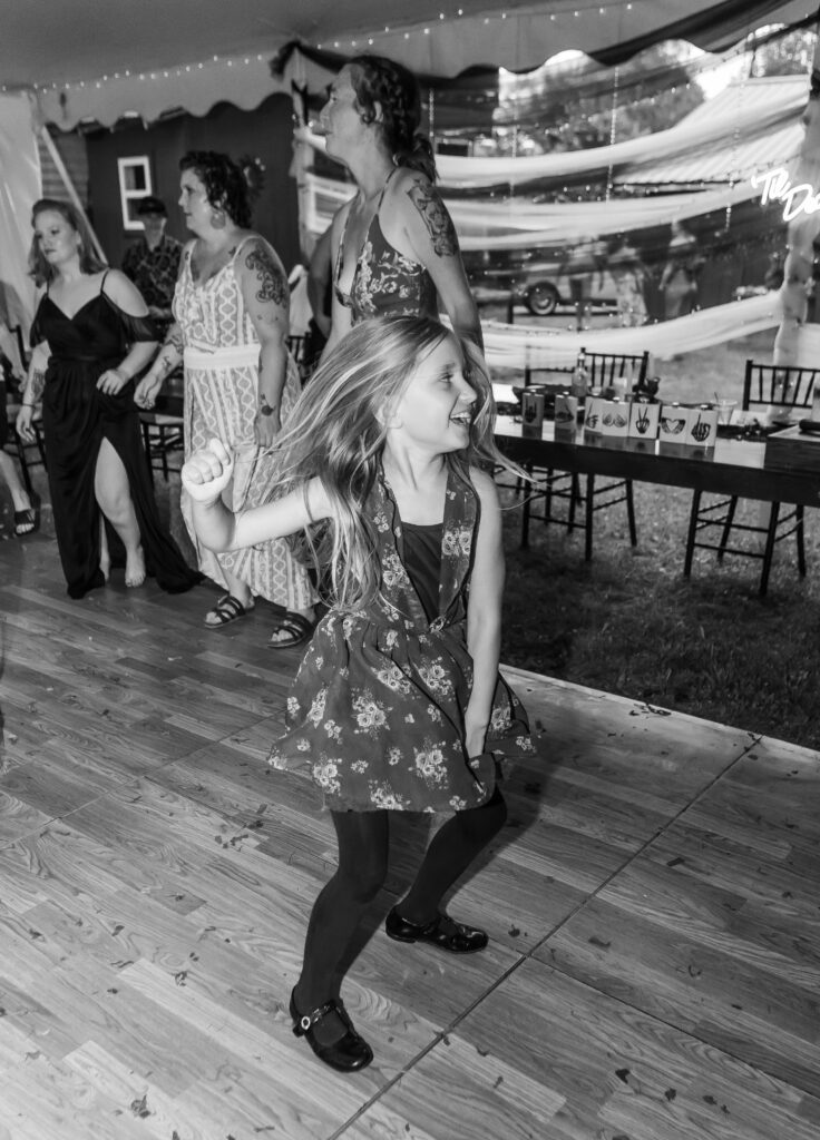 A little girl gets down to the music at a new hampshire wedding in northern nh. 