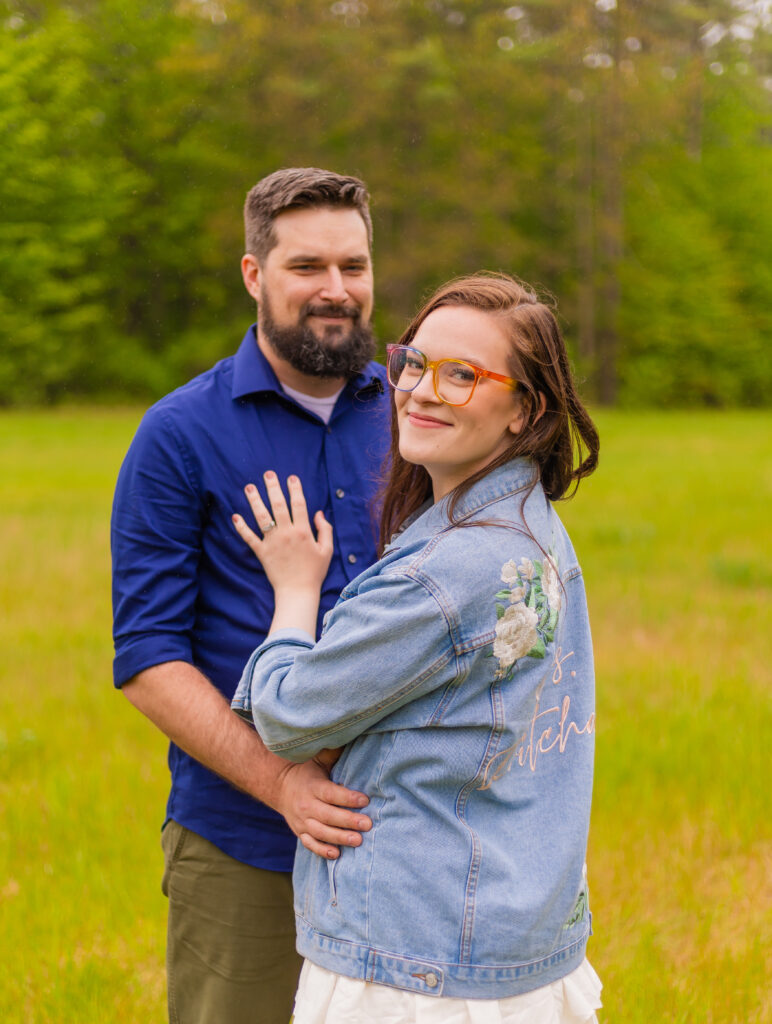 Katie looks back at the camera for their engagement session in NH