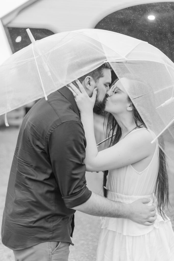 A couple under an umbrella in Plymouth NH