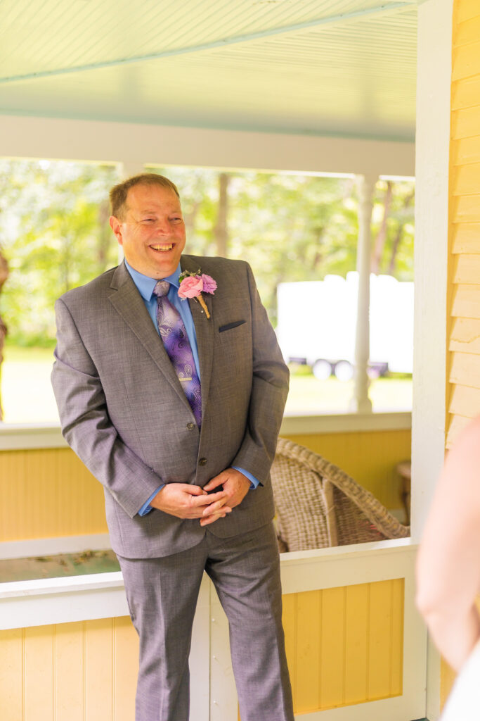 Dad grins with happiness at his daughter on her wedding day