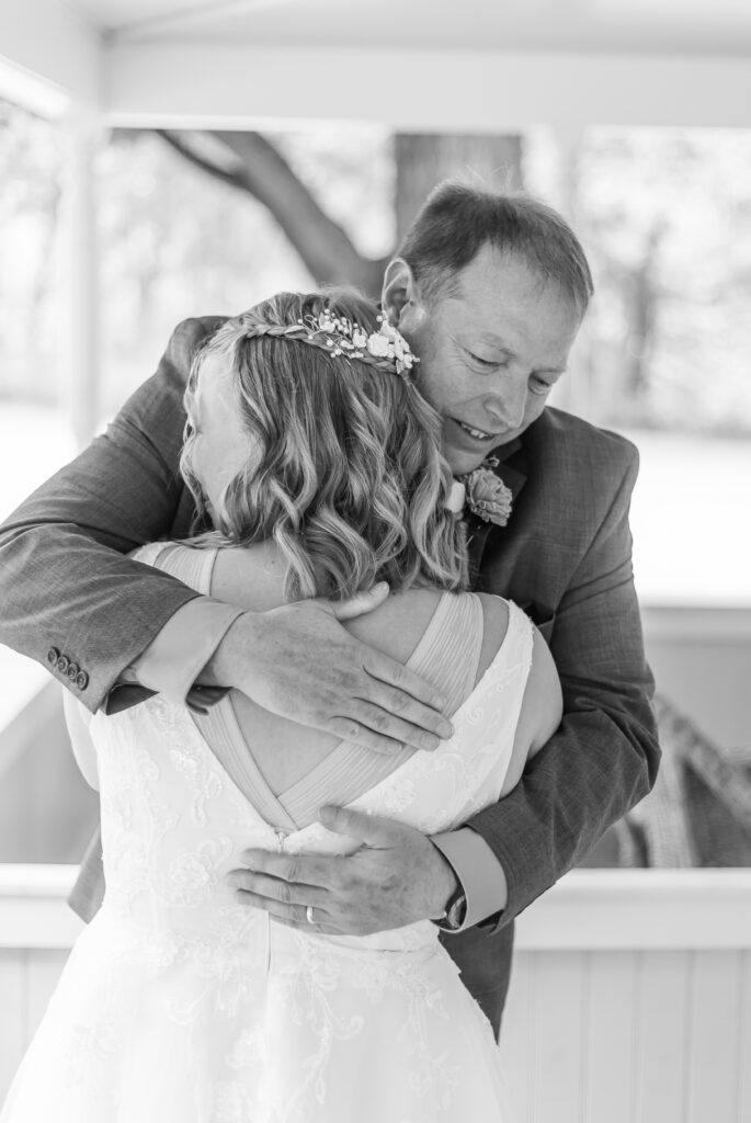 Dad and daughter share a hug on wedding day