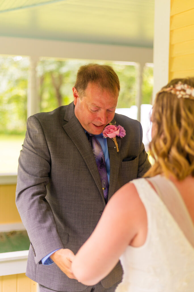 Dad admires his daughter as a bride.