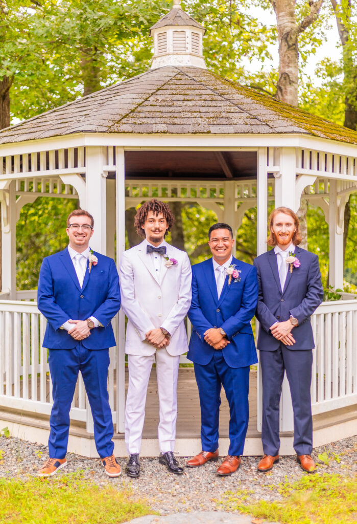 Groomsmen in front of wedding gazebo.