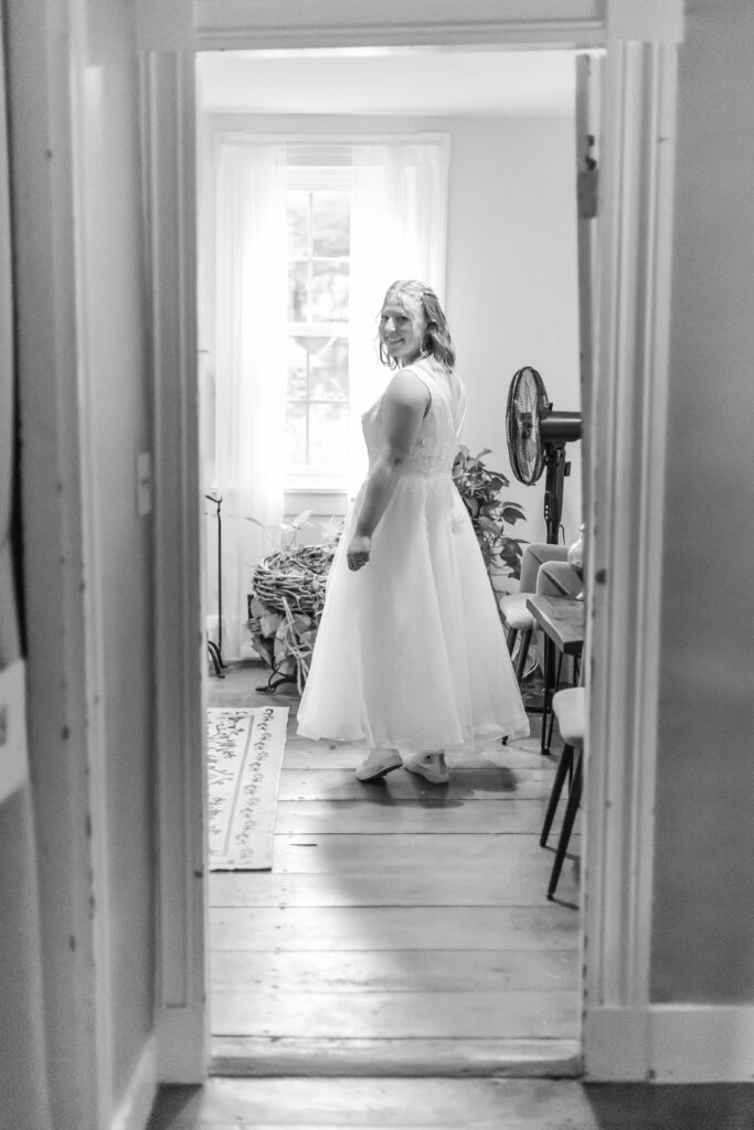 The bride looks back down the hall