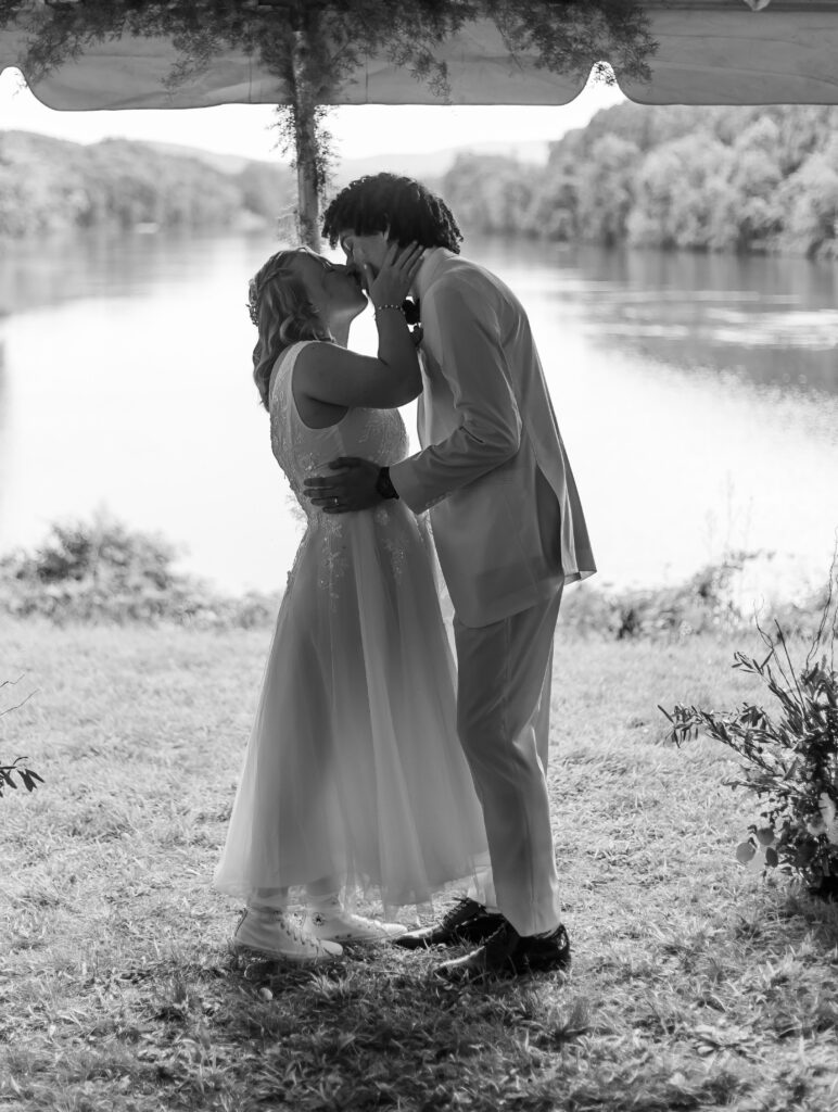 The bride and groom share their first kiss at their wedding at Stone Garden in Westmoreland, NH.