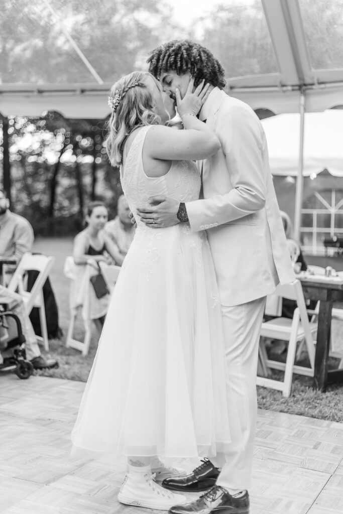 Bride and groom share a kiss after their first dance.