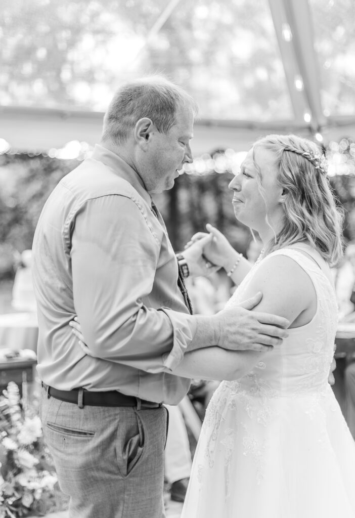 Bride gets emotional during father daughter dance at her wedding.