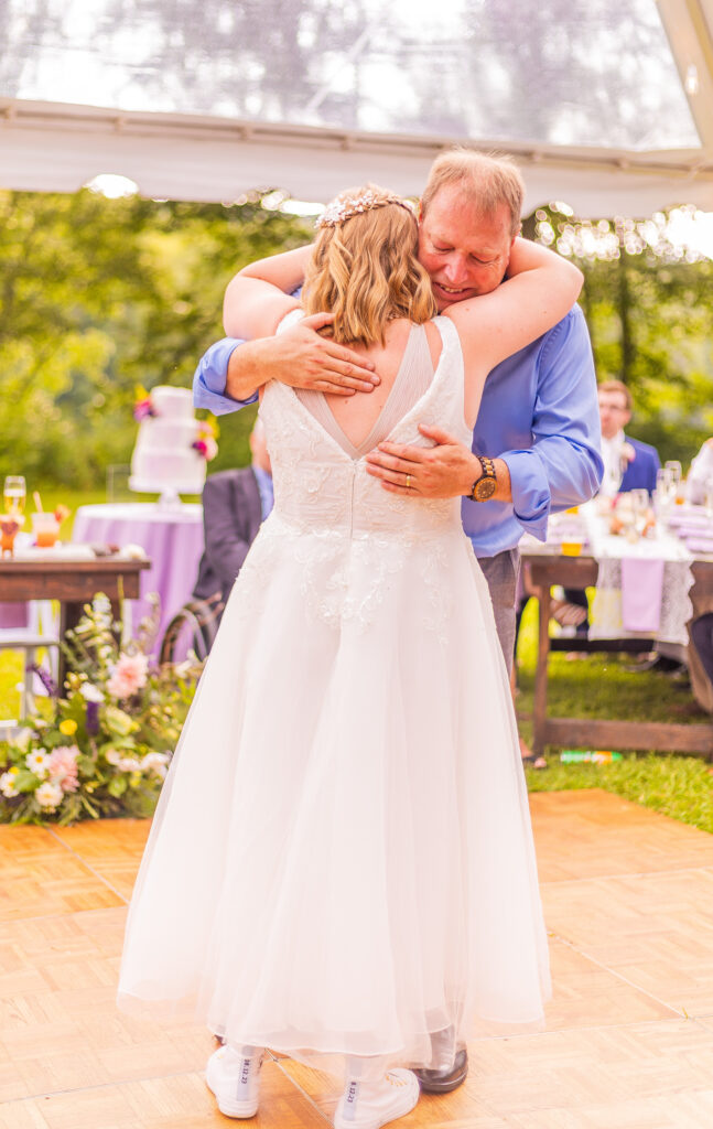 Dad and daughter share a hug after their dance.