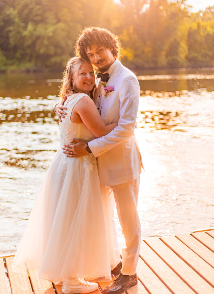 Bride and groom portraits during golden hour on the river.