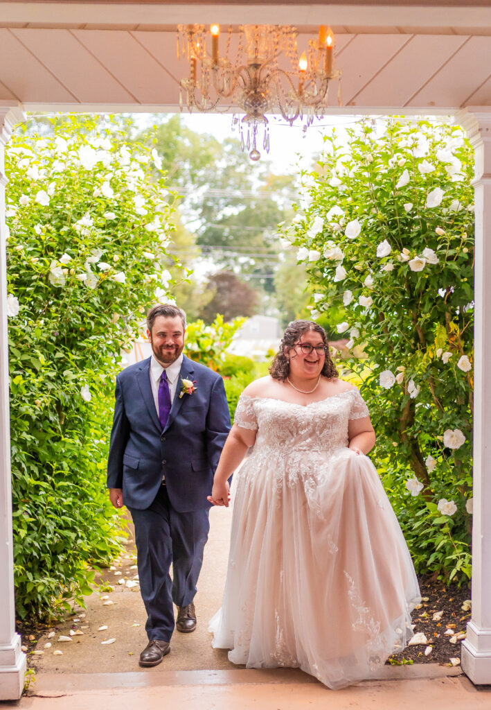 The bride and groom walk into their reception at their seacoast NH wedding venue. 