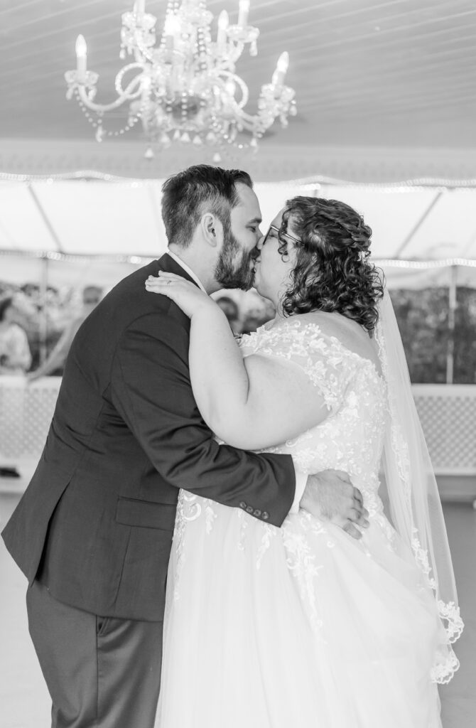 The bride and groom share a kiss during their first dance. 