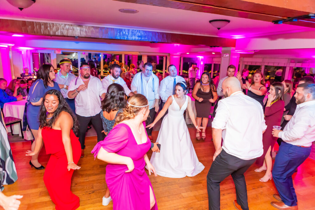 Bride and groom on the dance floor with all their guests at a wedding at Steele Hill Resorts in Sanbornton, New Hampshire.