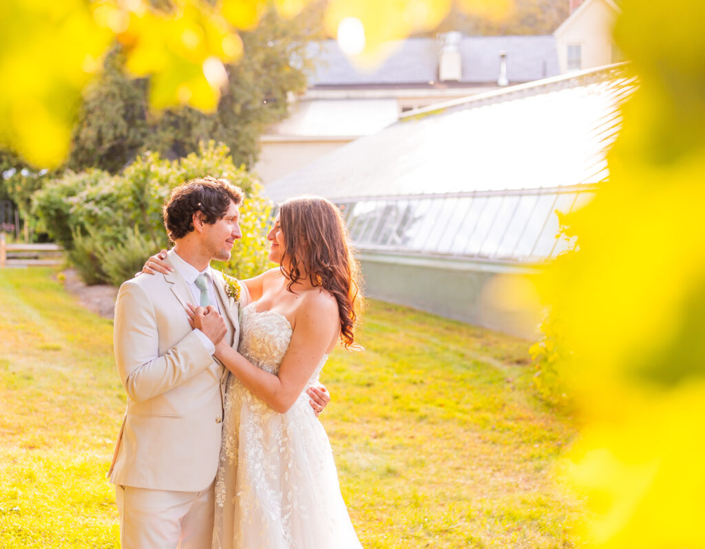 A newly married couple during golden hour at the Barn on the Pemi in Plymouth, New Hampshire. In 20 questions to ask your wedding photographer. 