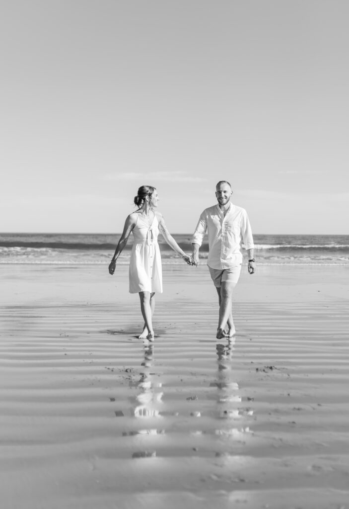 Bride and groom walking together on the beach for their NH seacoast elopement in Rye, NH.
