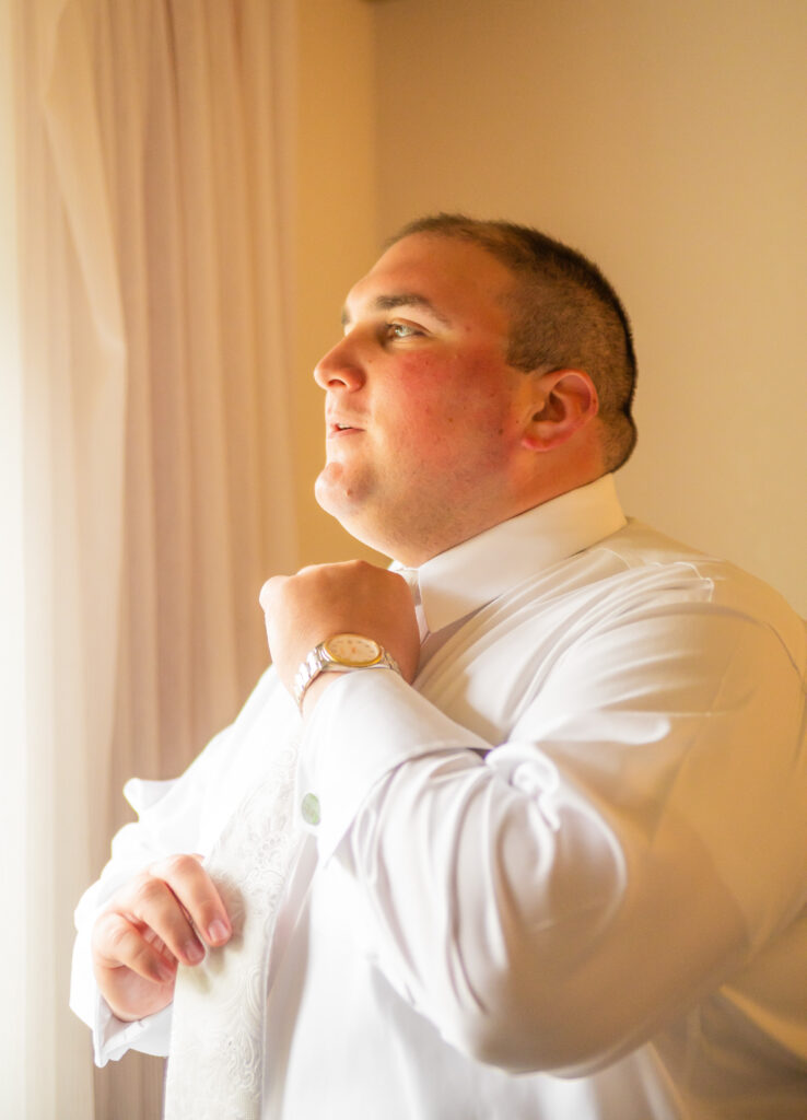 Groom gets final touches done to get dressed for his wedding at the Granite Rose in Hampstead, NH.