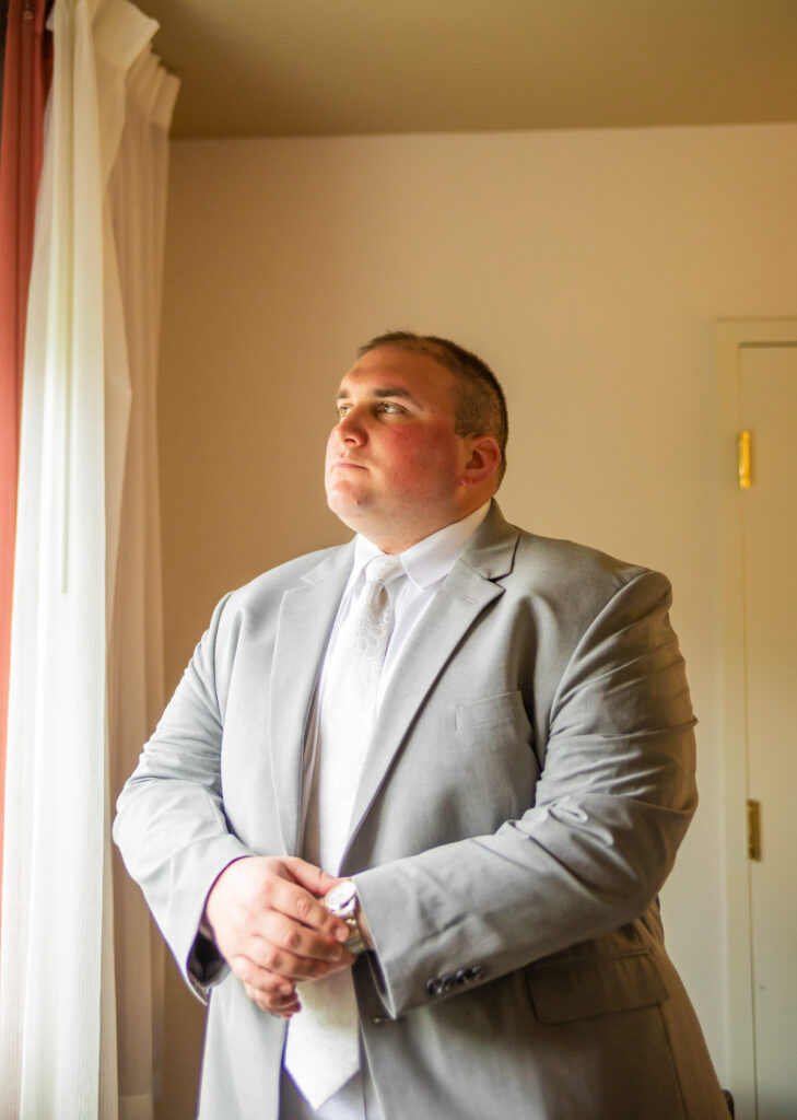 Groom adjusts his watch.