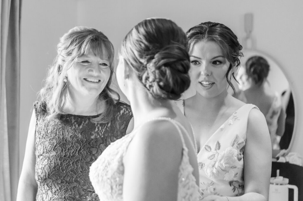 Mother of the bride and maid of honor help the bride get ready for her New Hampshire Wedding ceremony.