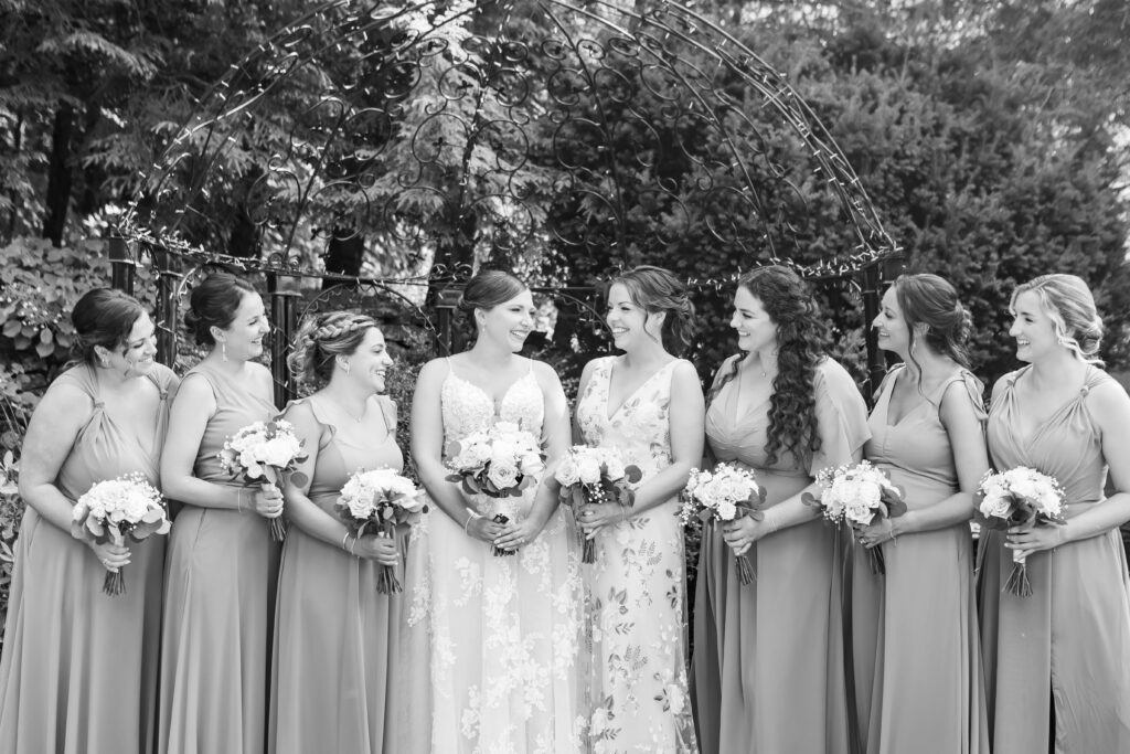 Bridal party laughing at each other while doing portraits.