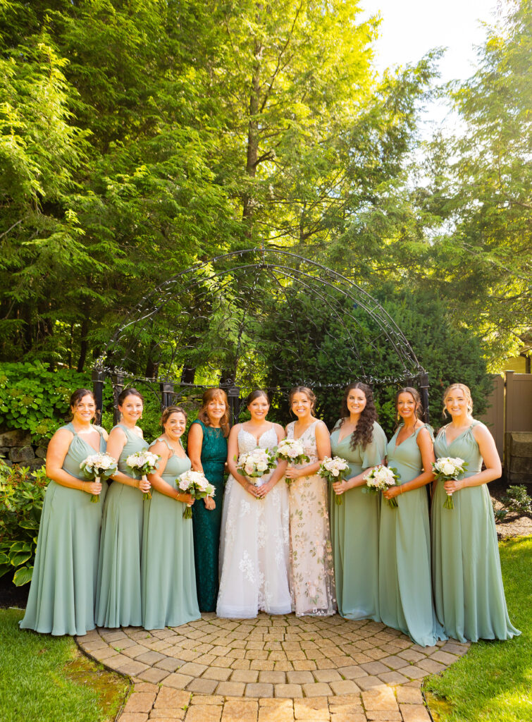 Bridal party stand together in the gardens at their NH Hampstead, NH.