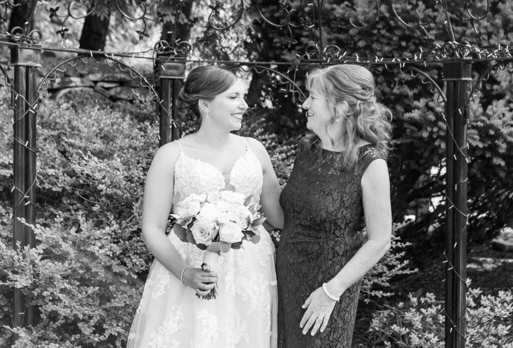 Bride and mother of the bride laughing together.