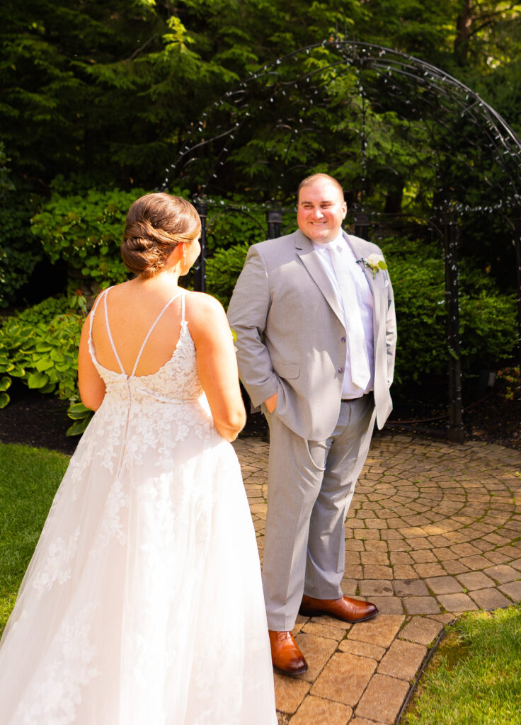 Groom is thrilled to see his bride in her wedding dress from Alexandra's bridal boutique in Fall River, MA.