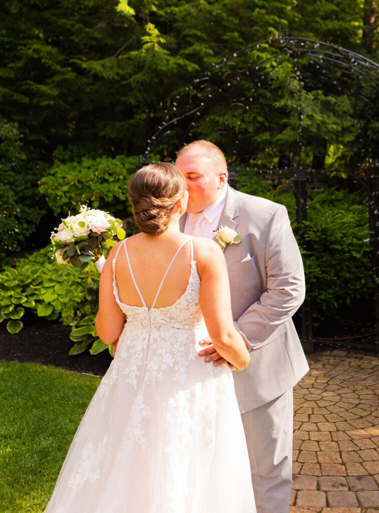 Bride and groom share a first kiss after their first look. 