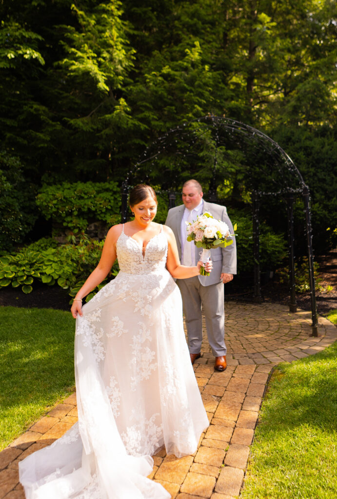 Bride showing off her wedding dress to her future husband.