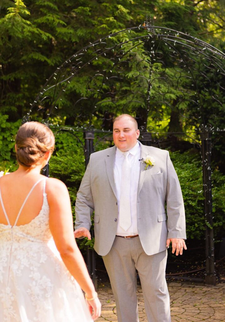 Groom admires his future wife in the terrace at the Granite Rose by Wedgewood Weddings.