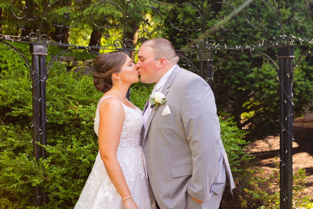 Bride and groom share a kiss after their vows.