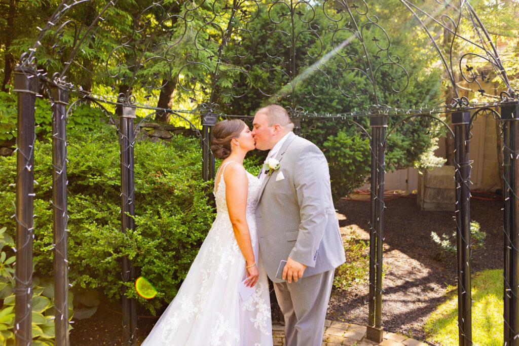 Bride and groom kiss after sharing intimate wedding vows.