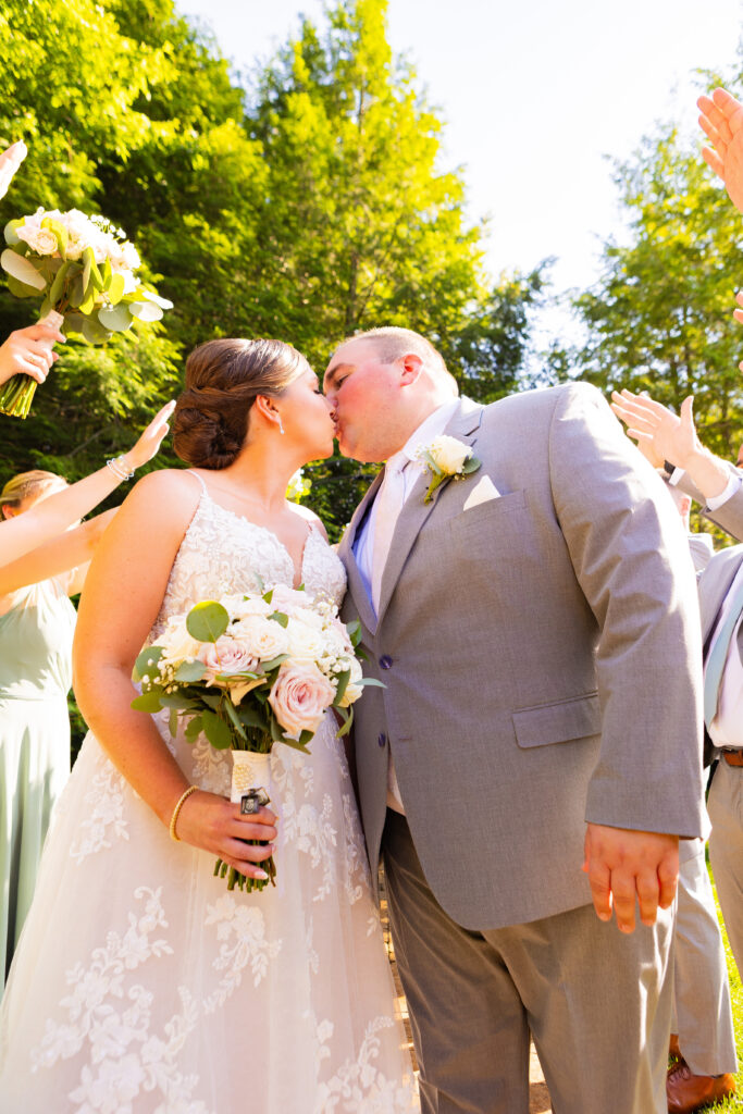 Bride and groom share a kiss.