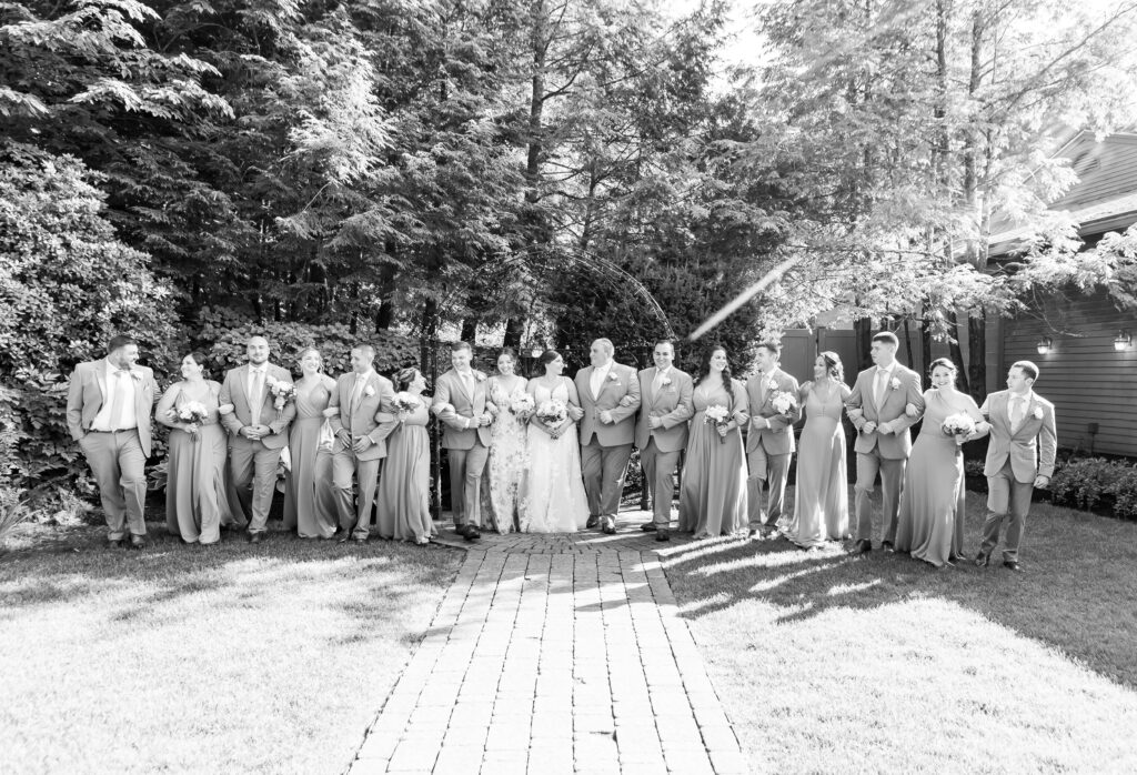 Wedding party link arms and walk together. 