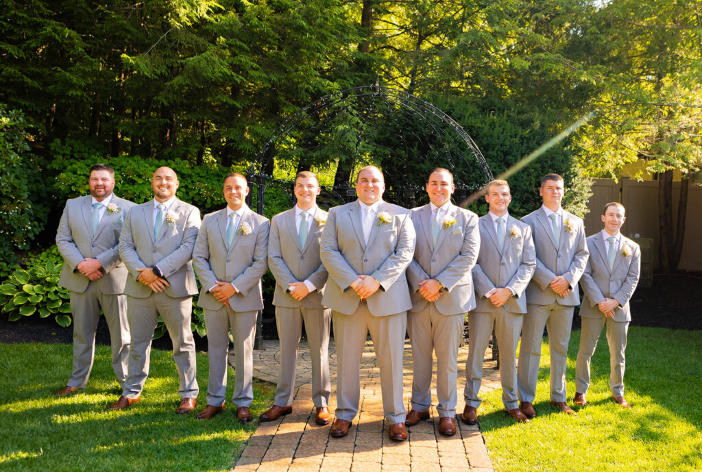 Groomsmen and groom pose at their NH wedding venue.