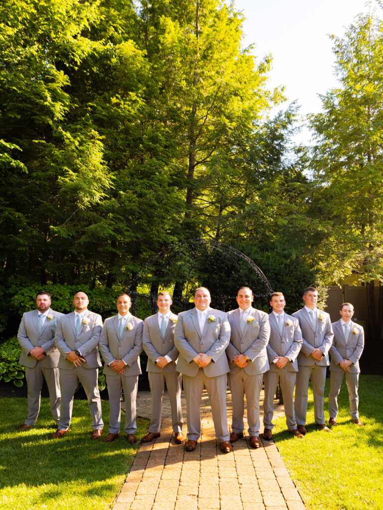 Groomsmen standing in a flying V.