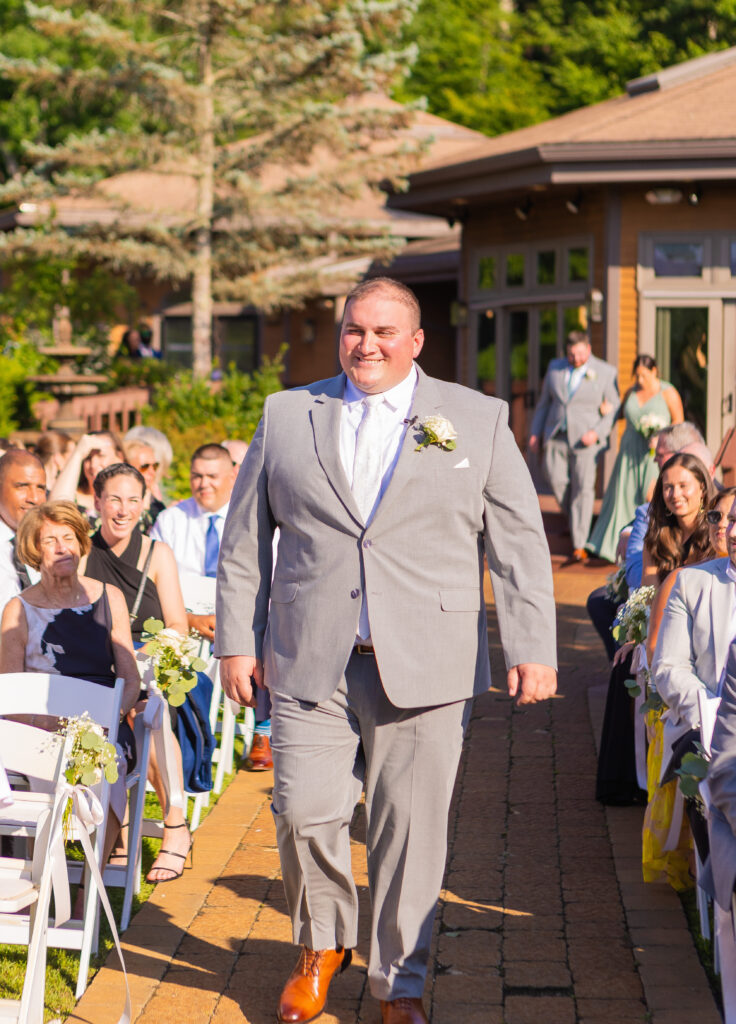 Groom walking down the aisle.