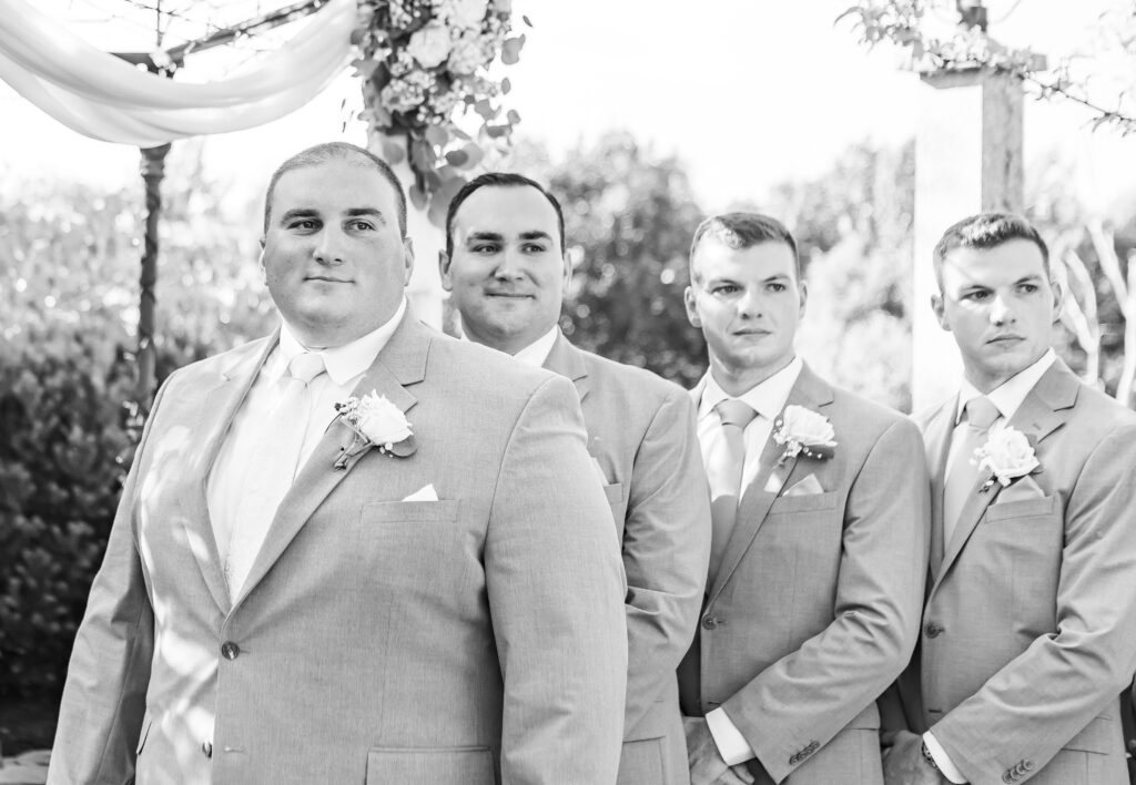 Groom reacts to his bride walking down the aisle.