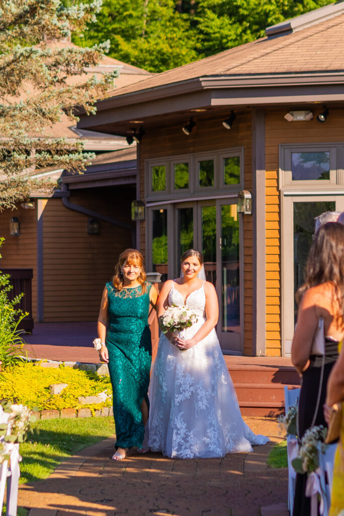 Bride walking with her mother down the aisle.