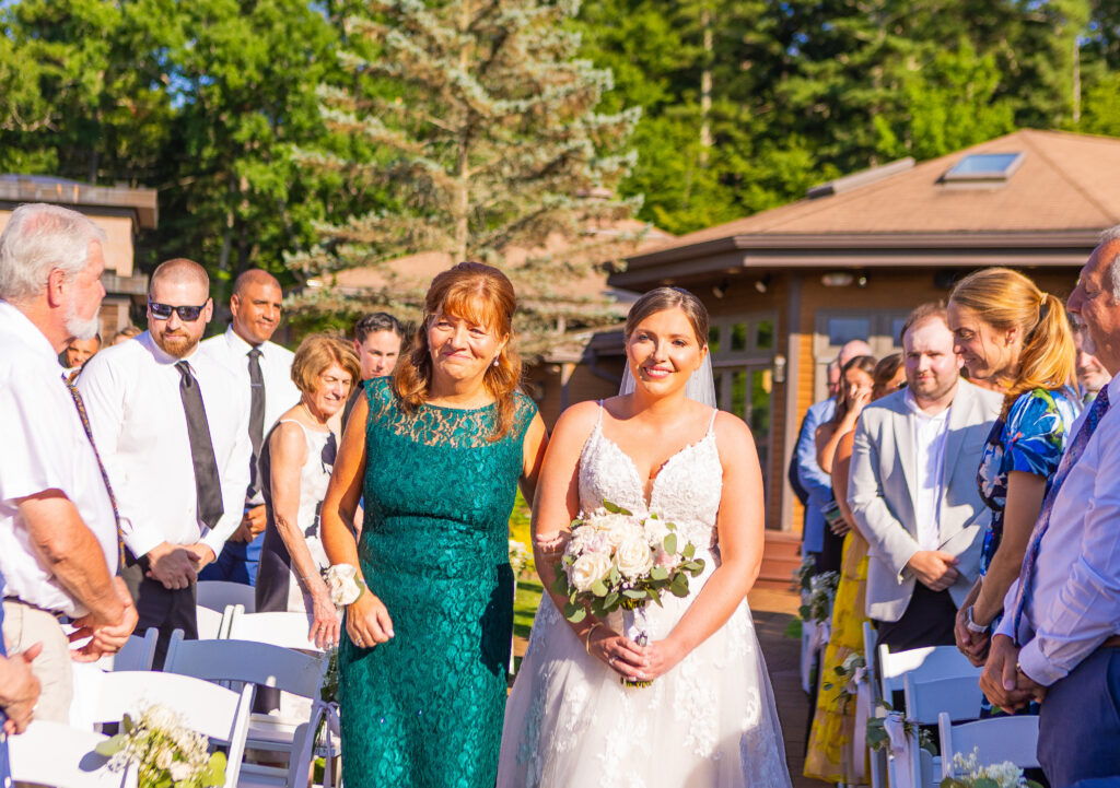 Mother is emotional walking her daughter down the aisle.