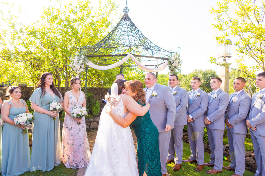 Mother hands her daughter off the the groom.